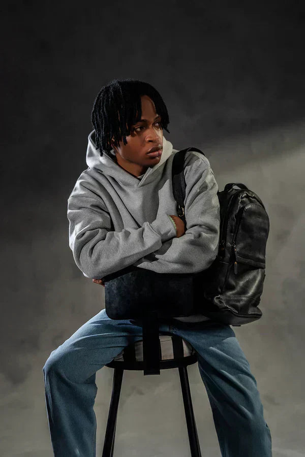 Grey oversized hoodie paired with light blue jeans