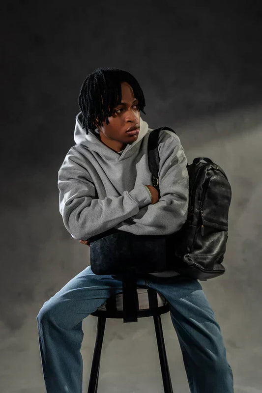 Grey oversized hoodie paired with light blue jeans