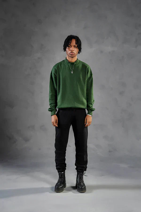 Straight leg sweatpants paired with green sweatshirt