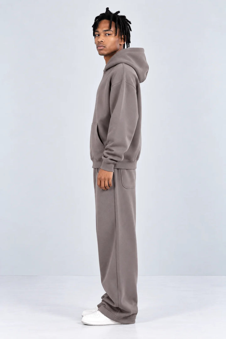 Warm grey hoodie and sweatpants set, side profile showing relaxed leg and hood
