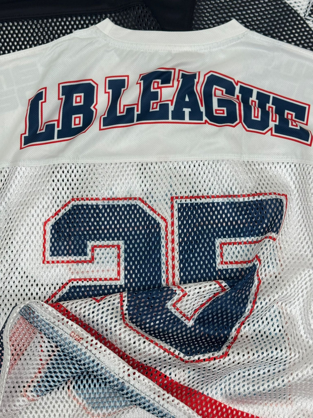 Loopback League Black sports jerseyand number '35' on a mesh background