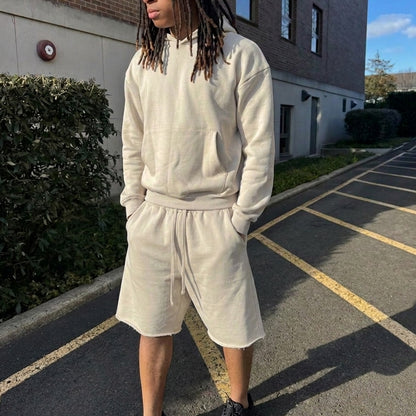 Loopback Apparel baggy fleece shorts in Cloud Dancer off-white, oversized fit with raw hem, worn with matching hoodie